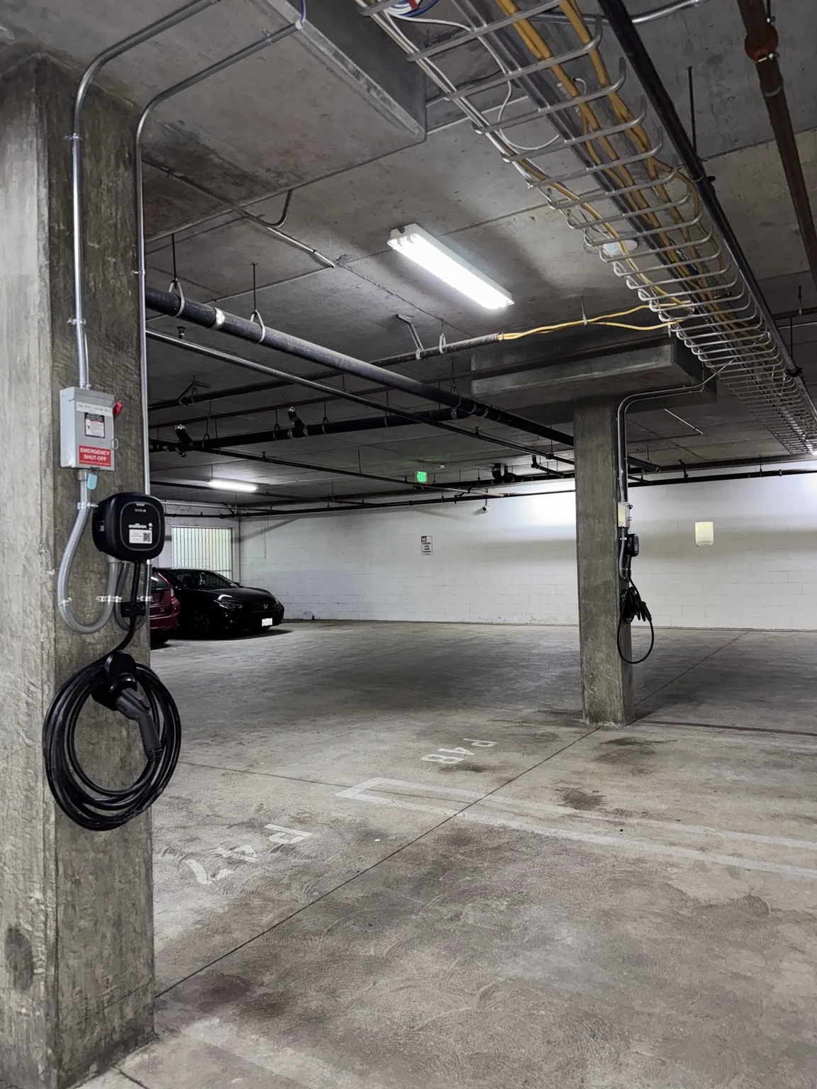 Multiple EV chargers installed in a commercial parking garage