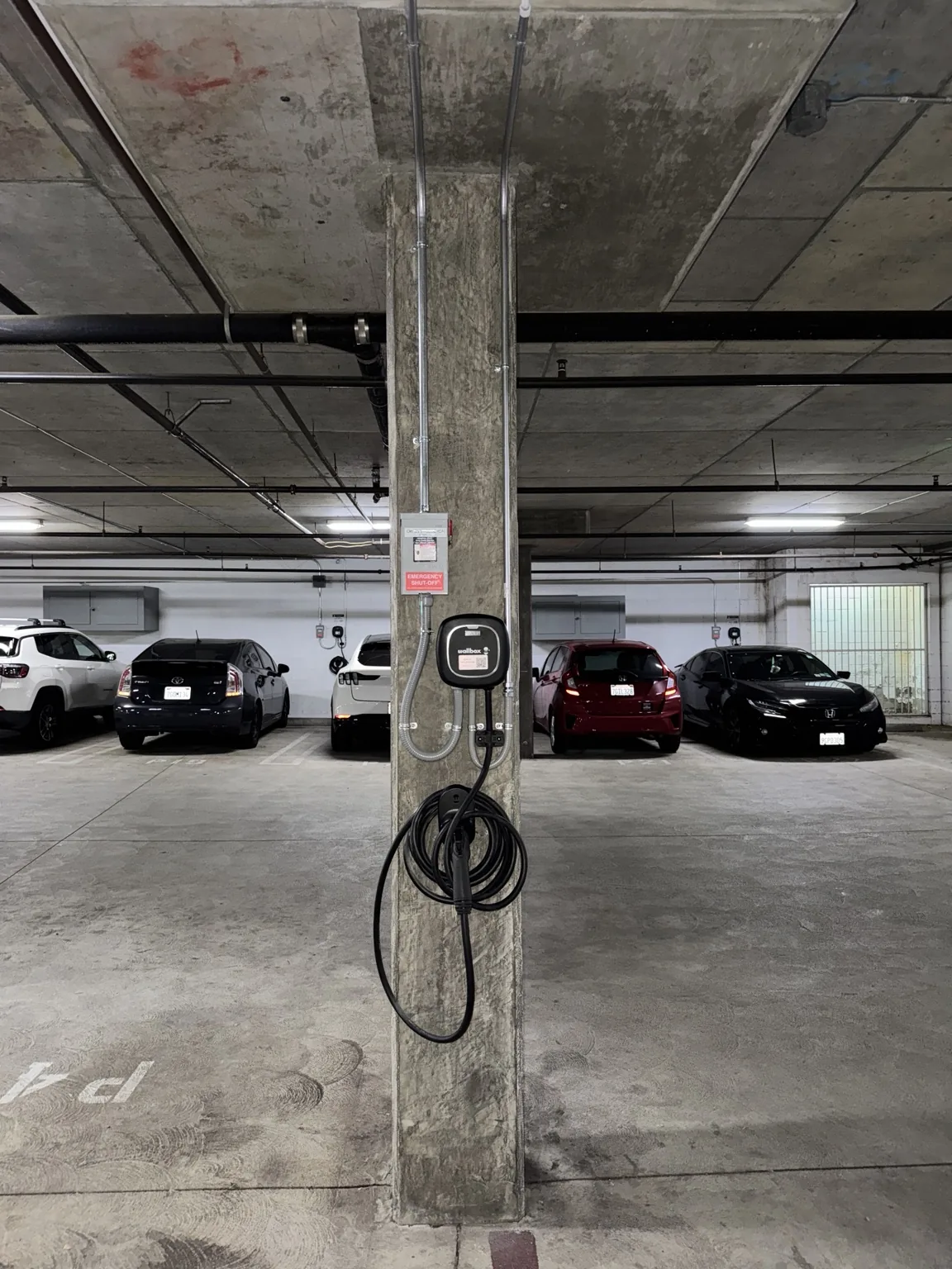 Wallbox EV charger installed on a concrete column in a parking garage